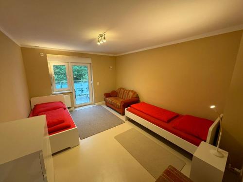 a small room with two beds and a couch at 3Raumwohnung mit Balkon in Leipzig Nord BMW, Amazon, Messe & Porsche in Taucha