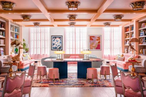 a lobby with pink furniture and a table and chairs at The Goodtime Hotel, Miami Beach a Tribute Portfolio Hotel in Miami Beach