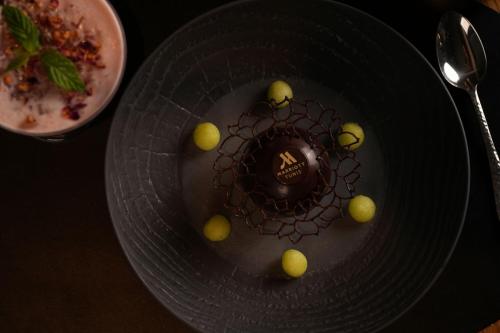 a plate with a chocolate dessert on a table at Tunis Marriott Hotel in Tunis