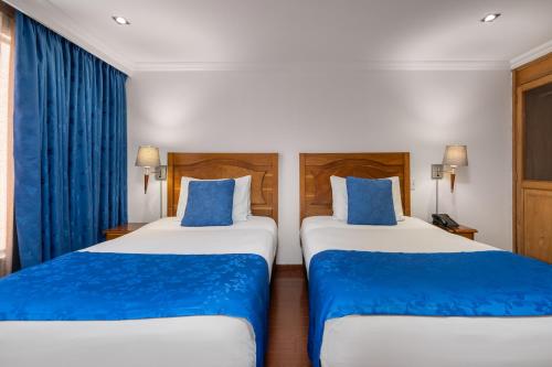 Postel nebo postele na pokoji v ubytování Hotel Egina Bogotá