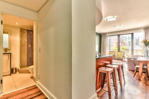 a kitchen and living room with a table and chairs at Rockwell Views in Cape Town