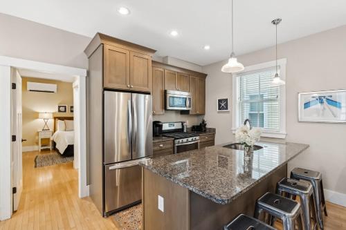 a kitchen with a refrigerator and a counter top at The Heart of the West End #3 in Portland