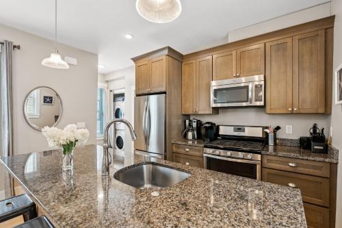 a kitchen with wooden cabinets and a granite counter top at The Heart of the West End #3 in Portland