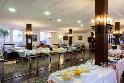 a buffet line with food on tables in a restaurant at El Cid in Sitges