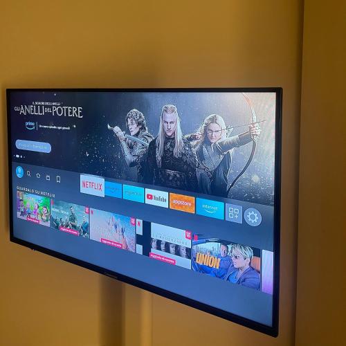 a television with a movie on the screen at La Suite del Maestro in Bienno