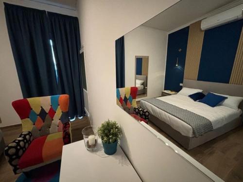 a bedroom with a bed and a table and a chair at SVR Palace in Bronte