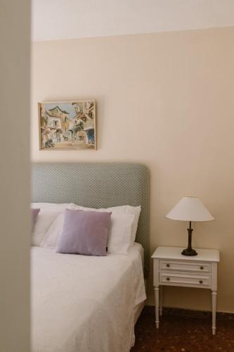 a bedroom with a bed and a table with a lamp at El Cid Country Club in Benidoleig