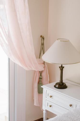 a bedroom with a white lamp and a window at El Cid Country Club in Benidoleig