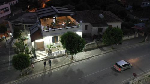 a house with a car parked in front of it at Vila Franko in Berat