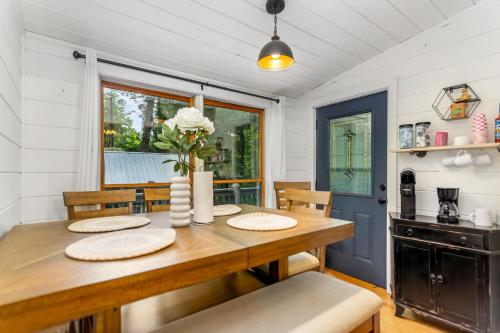 a dining room with a wooden table and chairs at Downward Dog Lodge - Hot Tub, Pool Table, Fireplace, Yoga Den in Blue Ridge