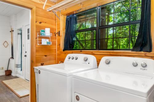 a kitchen with two washing machines and a window at Downward Dog Lodge - Hot Tub, Pool Table, Fireplace, Yoga Den in Blue Ridge