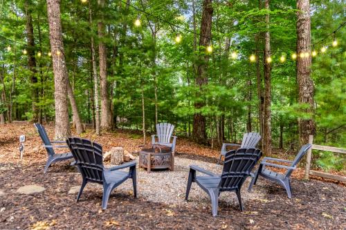 a group of chairs sitting around a fire pit at Downward Dog Lodge - Hot Tub, Pool Table, Fireplace, Yoga Den in Blue Ridge