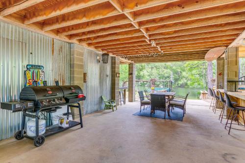a room with a grill and a table with chairs at Riverfront Milton Cabin with Boat Ramp and Dock! in Milton