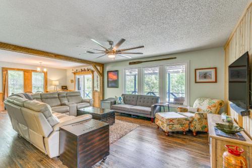 a living room with furniture and a ceiling fan at Riverfront Milton Cabin with Boat Ramp and Dock! in Milton
