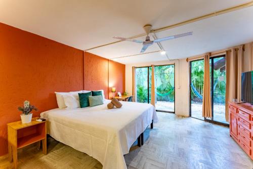 a bedroom with a large bed and a tv at Casa Rubia in Cancún