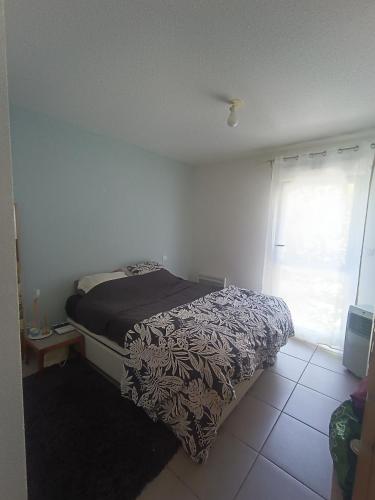 une chambre avec un lit et une fenêtre dans l'établissement Charmant T2 proche centre ville, à Narbonne