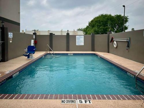 a swimming pool with blue water in front of a building at Motel 6-Mission, TX in Mission