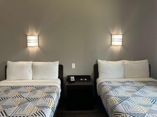 two beds sitting next to each other in a room at Motel 6-Mission, TX in Mission