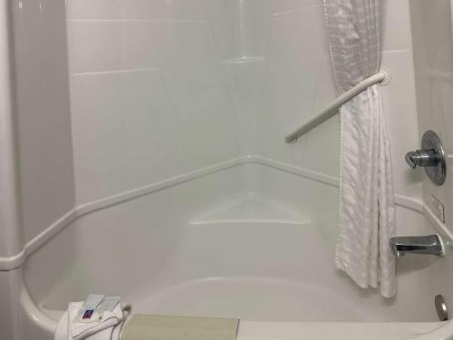 a bathroom with a bath tub with a shower curtain at Motel 6-Mission, TX in Mission