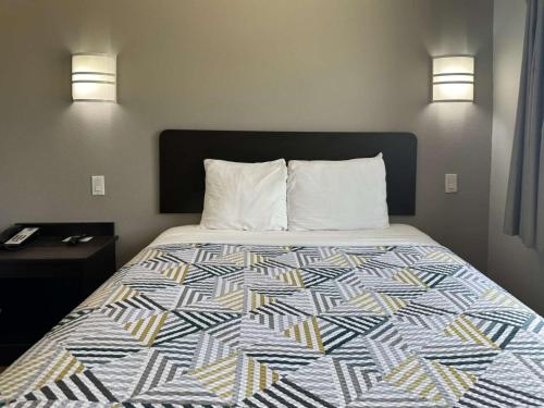 a bed in a hotel room with a colorful bedspread at Motel 6-Mission, TX in Mission