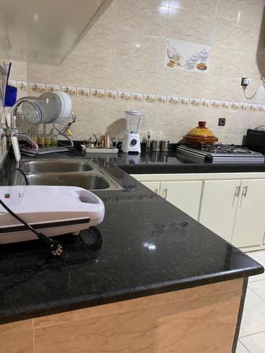 a kitchen with a sink and a counter top at apartamento la fontana 2 in Charf