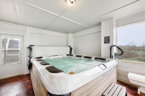 a large bath tub in a room with a window at The Pearl of Port A GW108 in Port Aransas