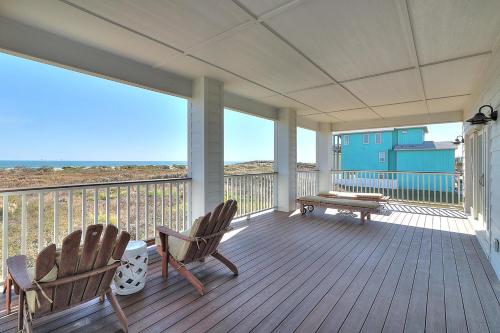 a porch with two chairs and a bench on it at The Pearl of Port A GW108 in Port Aransas