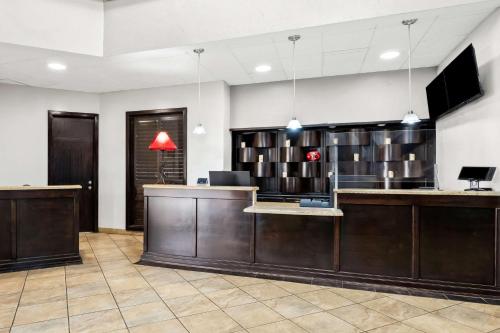 a lobby with a reception desk and a tv at SureStay Plus Hotel by Best Western Lubbock Medical Center in Lubbock