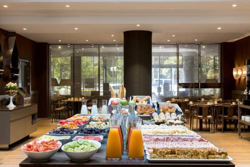 a buffet of food on a table in a restaurant at AC Hotel by Marriott Nice in Nice