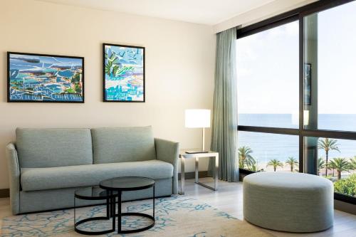 a living room with a couch and a table at AC Hotel by Marriott Nice in Nice