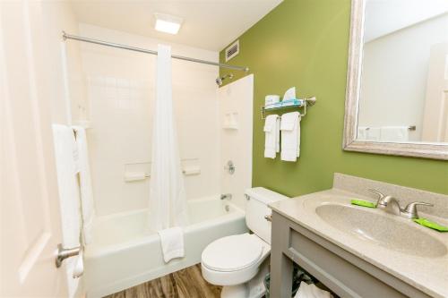 a bathroom with a white toilet and a sink at Brown County Inn in Nashville