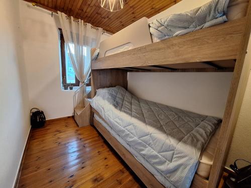 a bedroom with bunk beds in a house at Gold King Apartment in Áyios Vasílios
