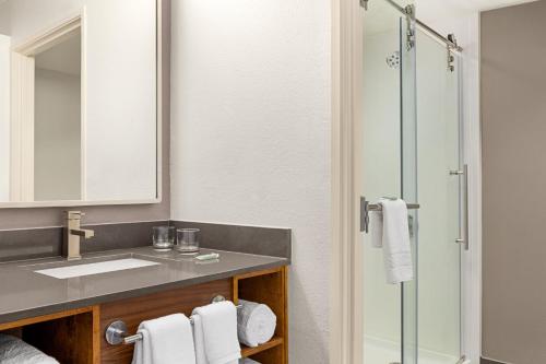 a bathroom with a sink and a shower at Courtyard Houston Sugar Land/Stafford in Stafford