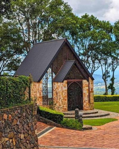 a small stone building with a black roof at Montville Attic in Montville