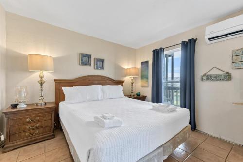 a bedroom with a bed with two towels on it at Bay Tree D5 in Port Aransas