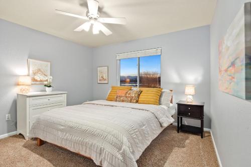 a bedroom with a bed and a ceiling fan at Family-friendly Home on Boyd Lake, Gorgeous Views! in Loveland
