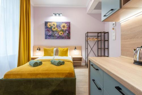 a bedroom with a bed and a painting on the wall at Budapest Holidays Downtown in Budapest