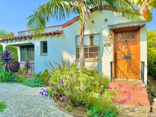 a house with a palm tree and a door at Prime West Los Angeles 4 Bedroom 2 Bathroom House in Los Angeles