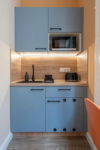 a kitchen with a sink and a microwave at Budapest Holidays Downtown in Budapest