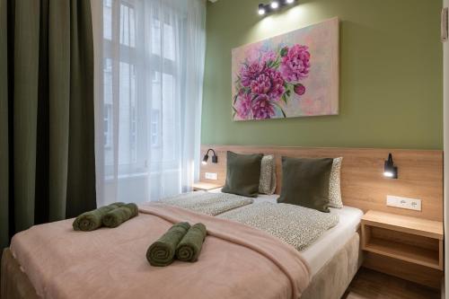 a bedroom with a large bed with two pillows on it at Budapest Holidays Downtown in Budapest