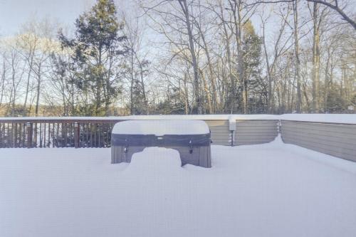 a snow covered bench sitting in the snow at 4-Season Home Fireplace and Fire Pit in Barnstead in Barnstead