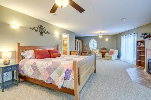 a bedroom with a bed and a living room at 4-Season Home Fireplace and Fire Pit in Barnstead in Barnstead