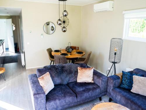 a living room with a couch and a table at Brabants Weelde in Molenschot