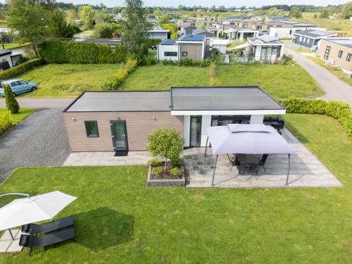 an aerial view of a house with tables and umbrellas at Brabants Weelde in Molenschot