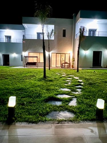 a walkway in the yard of a house at night at Villa Karama Essaouira Getaway in Bou Mkila