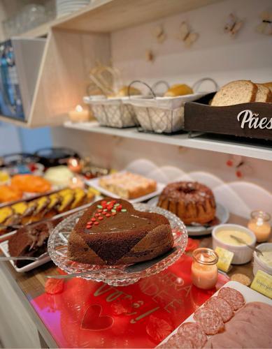 a table with a chocolate cake and other desserts at Pousada Villa Vantino in Penha