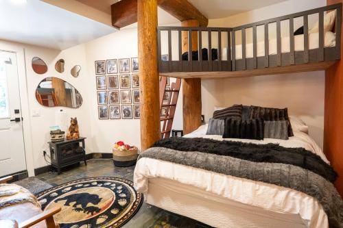a bedroom with a bed and a loft bed at Luxury Family Cabin at Summit West in Snoqualmie Pass