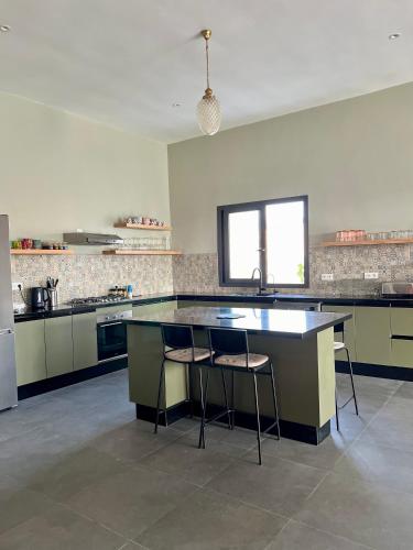 a kitchen with a large island in the middle at Villa Karama Essaouira Getaway in Bou Mkila