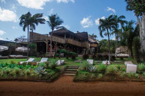 a large house with palm trees in front of it at Hurricane Jeri in Jericoacoara