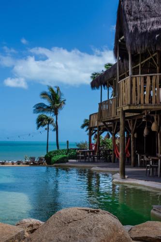 a resort on the beach with a view of the ocean at Hurricane Jeri in Jericoacoara